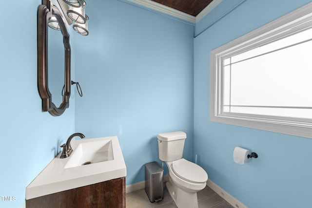 bathroom featuring tile patterned flooring, vanity, toilet, and baseboards