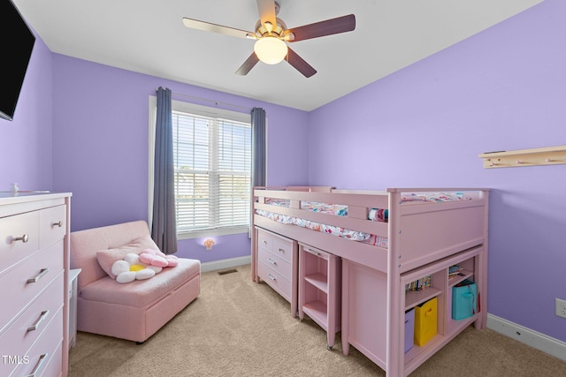 bedroom with light carpet, a ceiling fan, visible vents, and baseboards