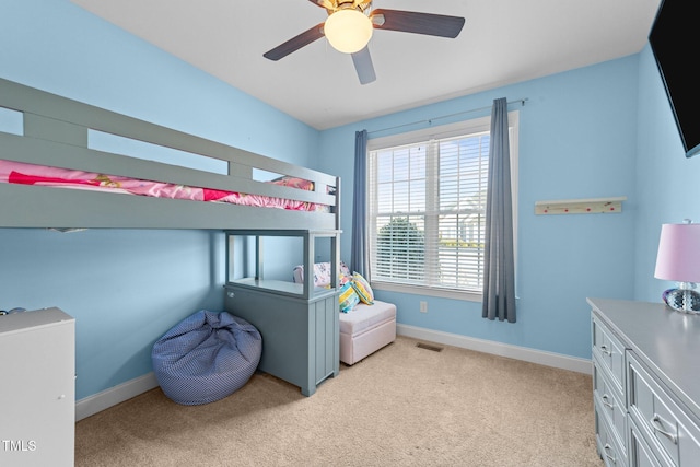 bedroom with light carpet, a ceiling fan, visible vents, and baseboards