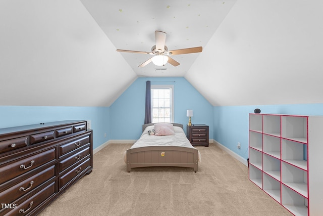 bedroom with ceiling fan, baseboards, vaulted ceiling, and light colored carpet