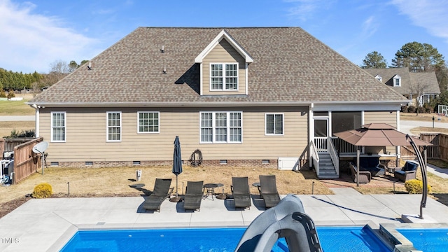 rear view of property with a shingled roof, crawl space, and a patio area