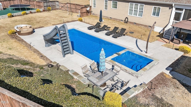 view of pool featuring a trampoline, a fenced in pool, a patio area, and a fenced backyard