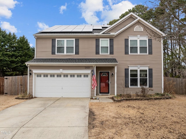 front of property featuring a garage and solar panels