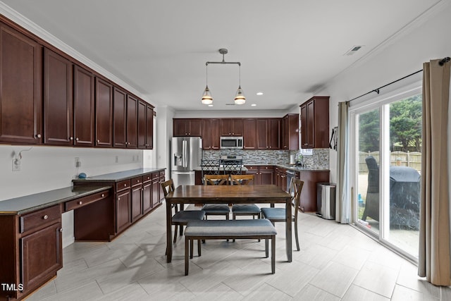 kitchen with decorative backsplash, hanging light fixtures, stainless steel appliances, crown molding, and dark brown cabinets