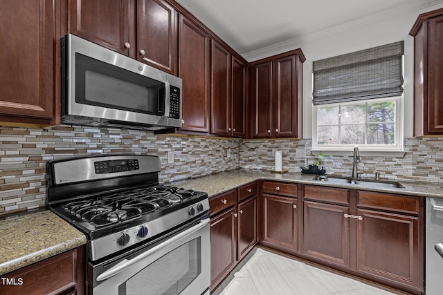 kitchen featuring sink, crown molding, appliances with stainless steel finishes, light stone countertops, and decorative backsplash