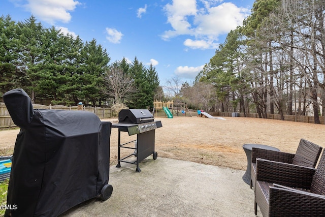 view of patio / terrace featuring a playground and area for grilling