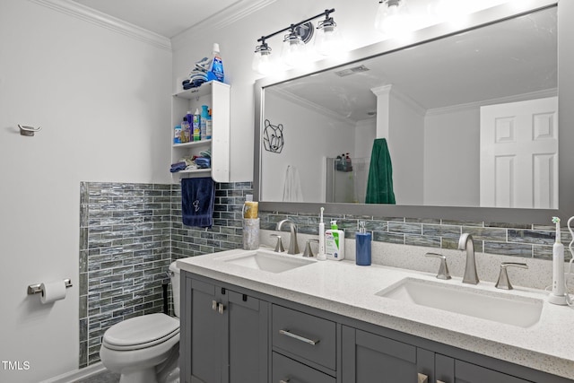 bathroom with tile walls, vanity, ornamental molding, and toilet