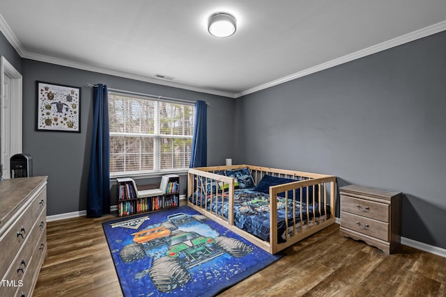 bedroom featuring dark hardwood / wood-style flooring and crown molding