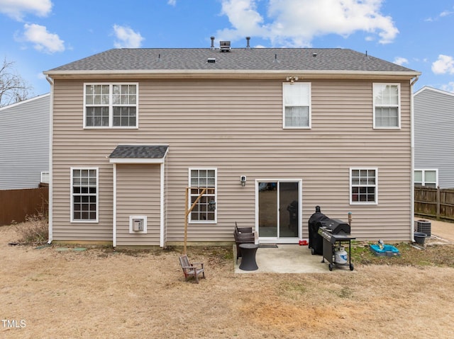 back of property with a patio area, central air condition unit, and a lawn