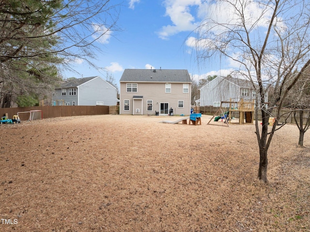 rear view of house featuring a playground