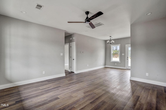 unfurnished living room featuring dark hardwood / wood-style flooring and ceiling fan with notable chandelier