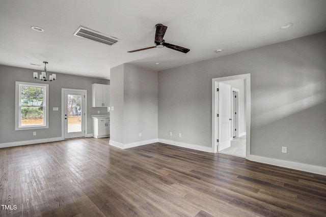 unfurnished living room featuring ceiling fan with notable chandelier and hardwood / wood-style floors