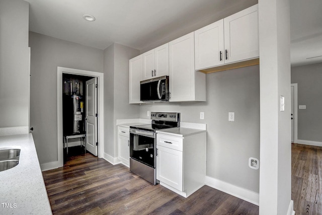 kitchen with sink, dark wood-type flooring, white cabinets, and appliances with stainless steel finishes