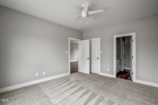 unfurnished bedroom with connected bathroom, ceiling fan, and dark colored carpet