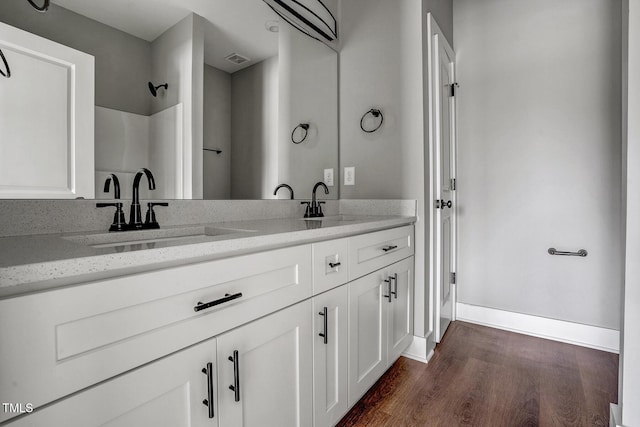 bathroom with hardwood / wood-style flooring and vanity