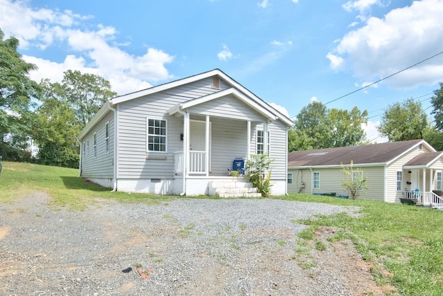 bungalow with a porch and a front yard