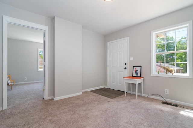 unfurnished room with light colored carpet