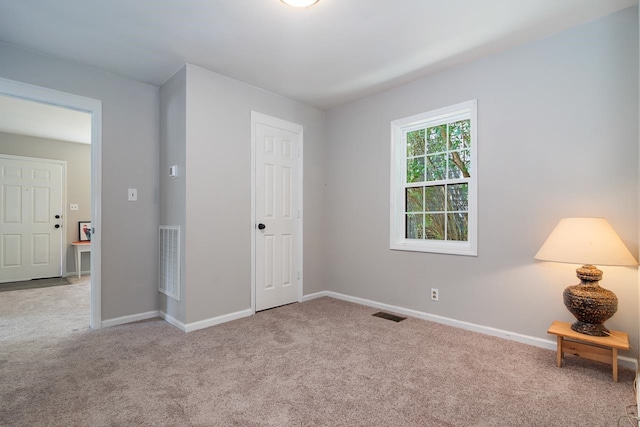 unfurnished bedroom featuring light colored carpet