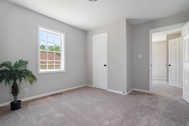 unfurnished bedroom with light colored carpet