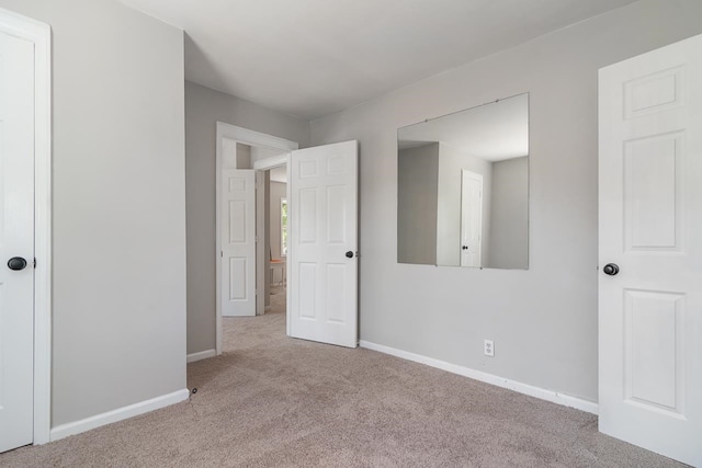 unfurnished bedroom featuring light colored carpet