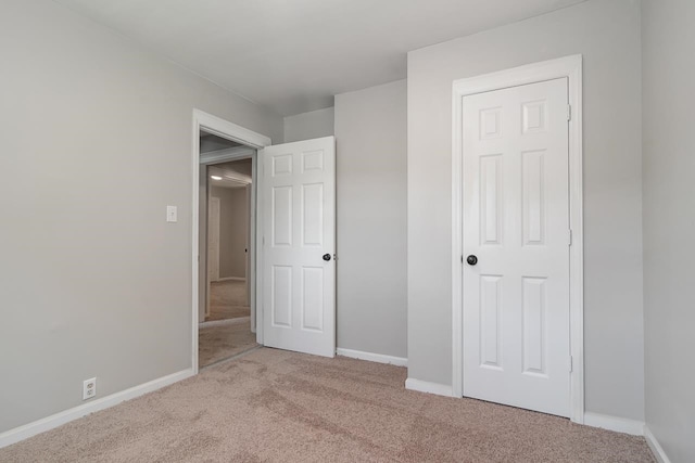 unfurnished bedroom with light carpet