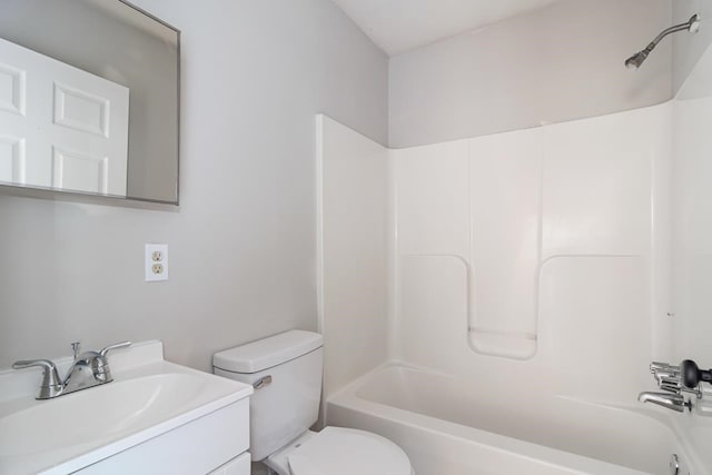 full bathroom featuring washtub / shower combination, vanity, and toilet