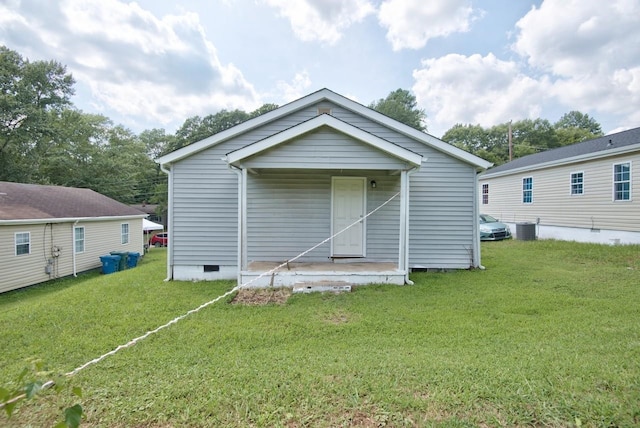 back of property featuring central AC unit and a lawn