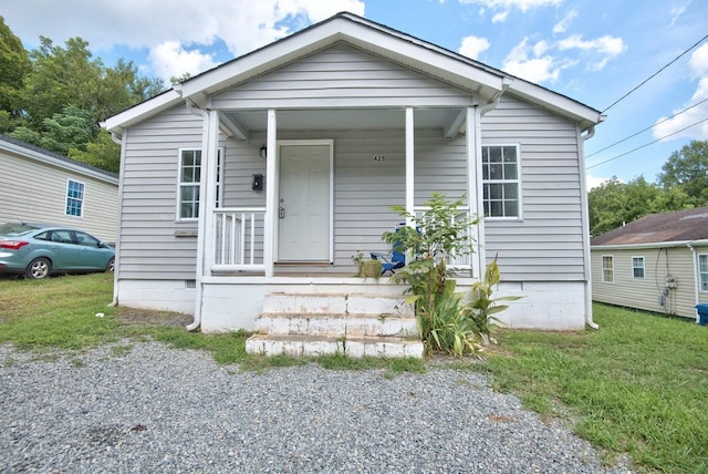 bungalow-style home with a front yard