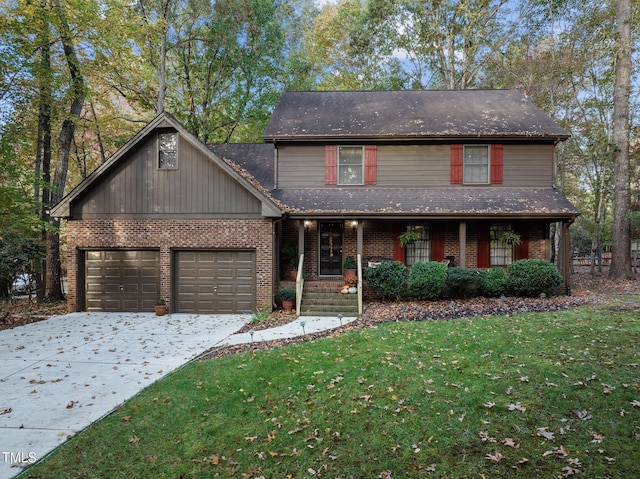 view of property featuring a garage, a front yard, and a porch