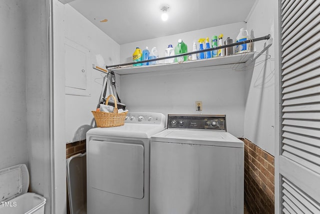 clothes washing area with separate washer and dryer