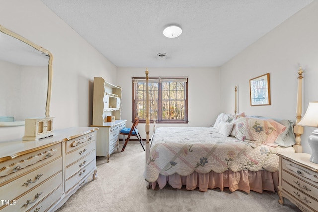 carpeted bedroom featuring a textured ceiling