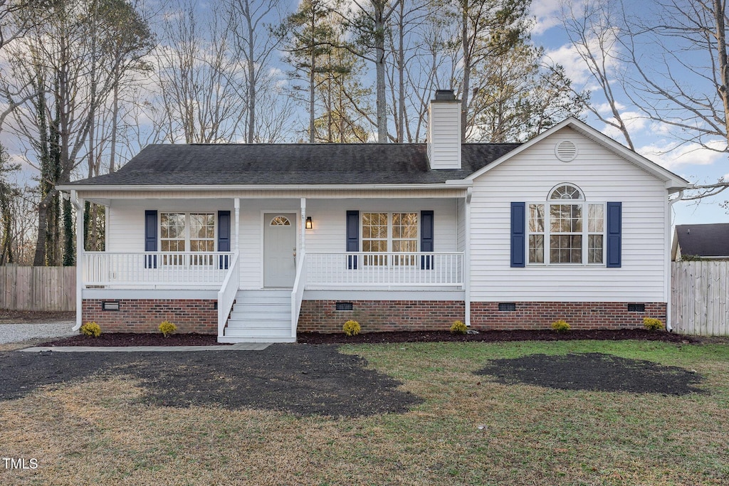 single story home with a front yard and covered porch