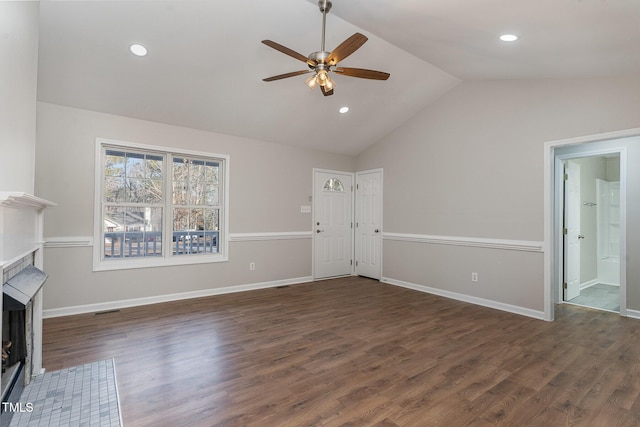 unfurnished living room with vaulted ceiling, dark wood-type flooring, and ceiling fan