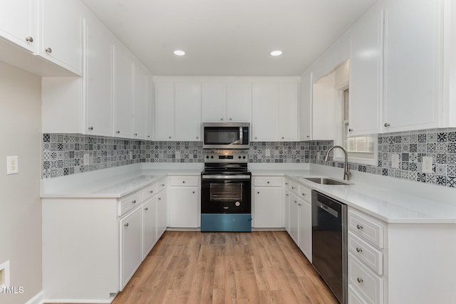 kitchen with sink, stainless steel appliances, and white cabinets