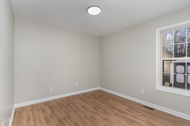 spare room with hardwood / wood-style floors