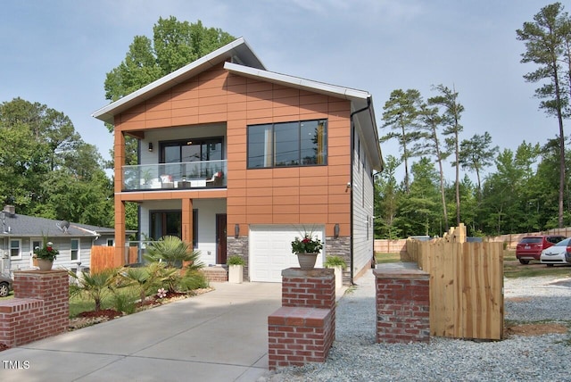 contemporary house with a garage and a balcony