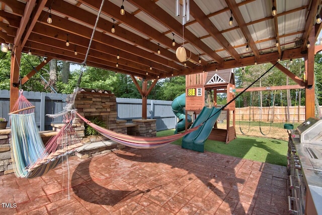 view of playground with a patio area