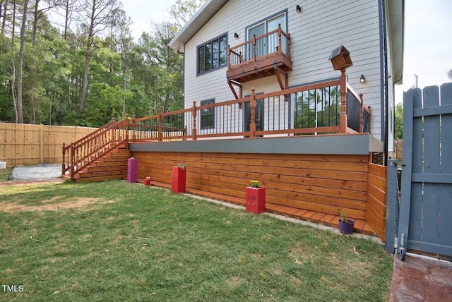 exterior space with a lawn and a balcony