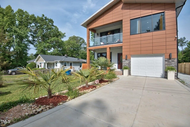 view of front of home with a balcony and a garage