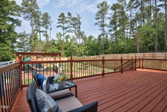 wooden terrace with outdoor lounge area and a playground