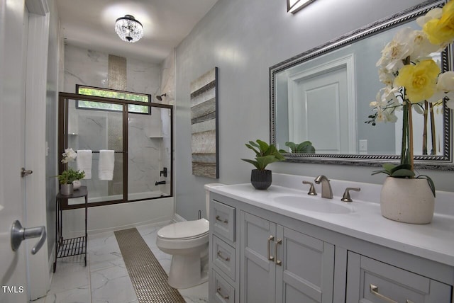 full bathroom featuring bath / shower combo with glass door, vanity, and toilet