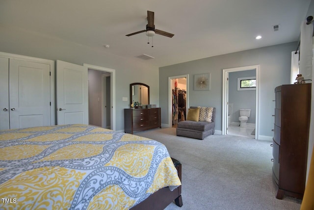 carpeted bedroom with connected bathroom, a spacious closet, a closet, and ceiling fan