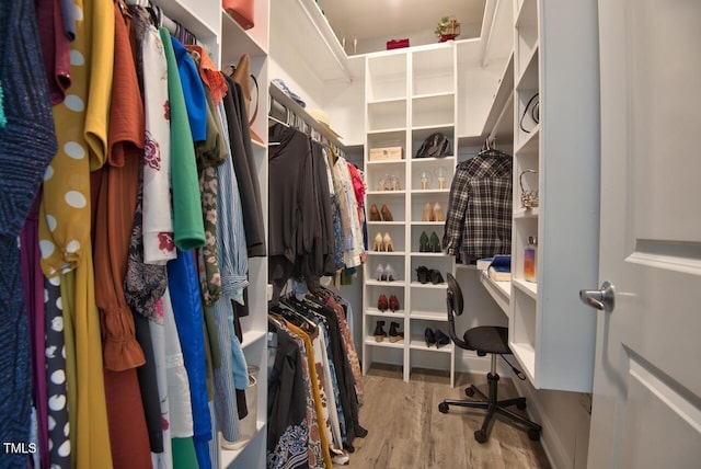 walk in closet with hardwood / wood-style floors