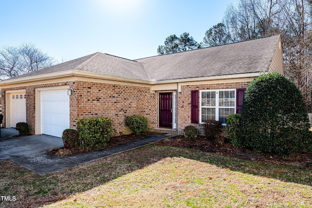 view of front of property featuring a garage and a front lawn