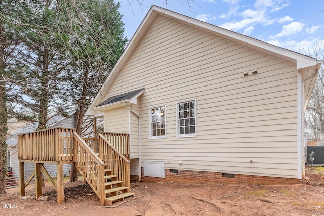 rear view of property featuring a wooden deck