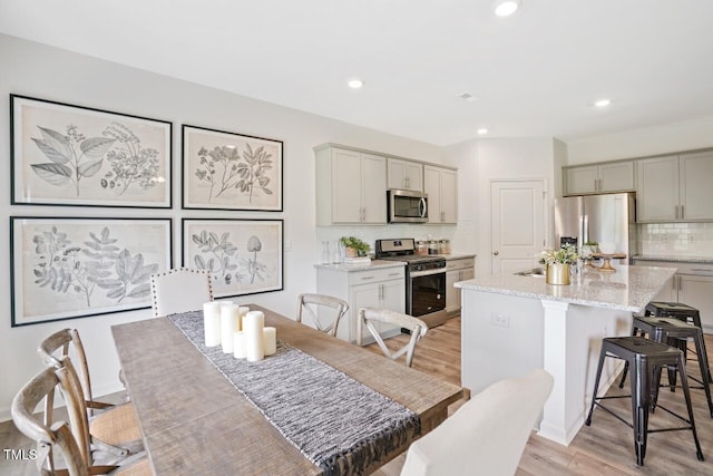 dining area with light hardwood / wood-style floors