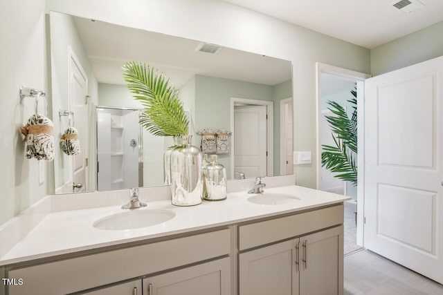 bathroom with vanity and a shower with shower door