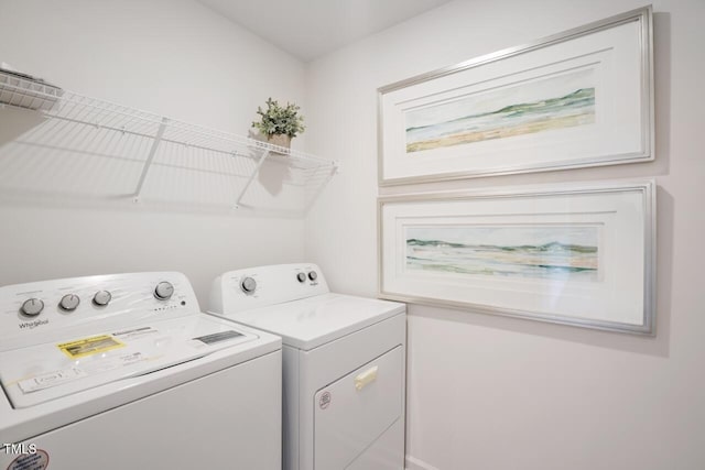 clothes washing area with separate washer and dryer