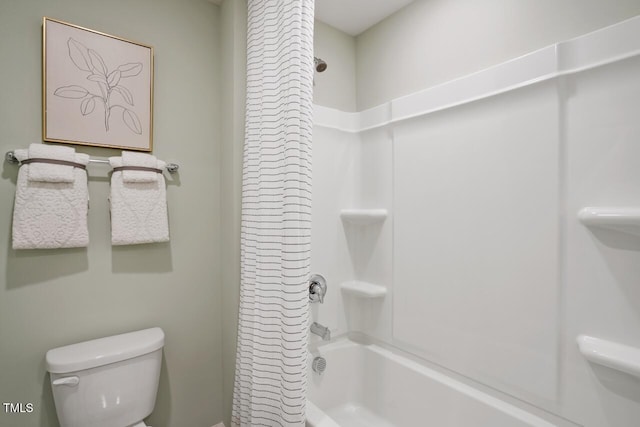 bathroom featuring shower / bath combination with curtain and toilet