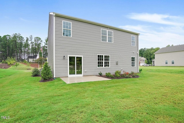 rear view of house featuring a yard and a patio